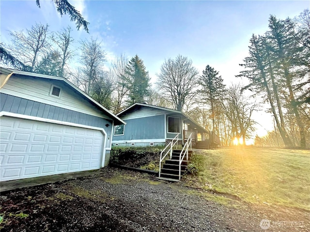 7116 Comanche Ln SW, Olympia, WA 98512 - view of property exterior featuring crawl space, dirt driveway, an outdoor structure, a garage, and stairs