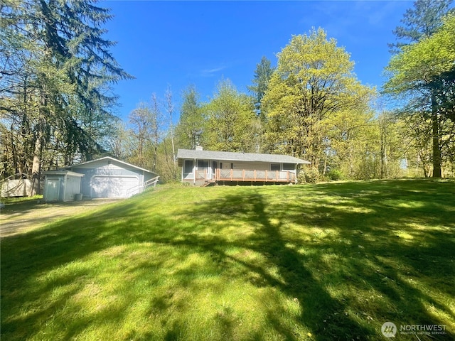 7116 Comanche Ln SW, Olympia, WA 98512 - view of yard with an outdoor structure, a detached garage, and a deck
