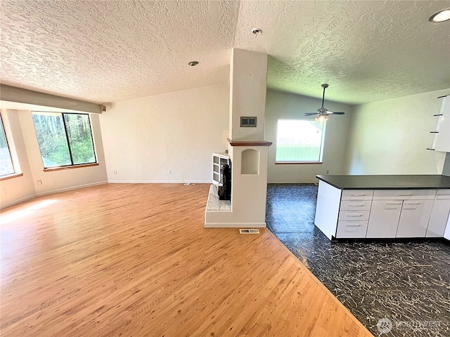 7116 Comanche Ln SW, Olympia, WA 98512 - kitchen featuring wood finished floors, a textured ceiling, and open floor plan