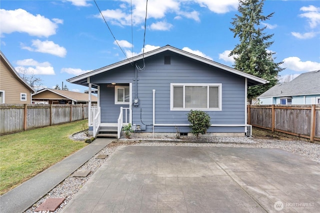 rear view of property with a patio, a yard, and a fenced backyard