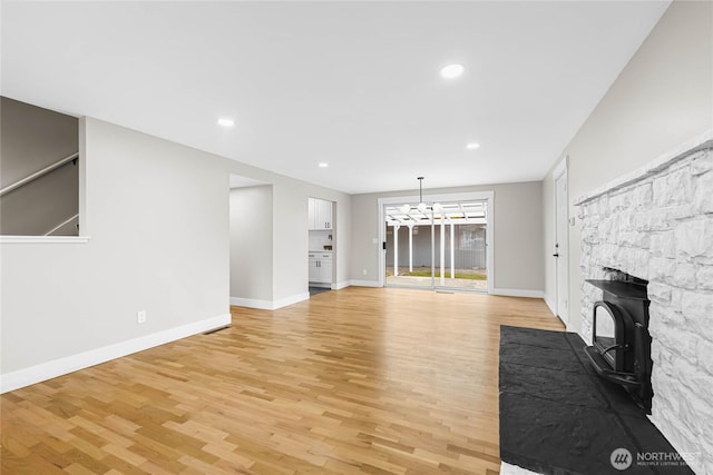 unfurnished living room featuring light wood-type flooring, baseboards, and recessed lighting