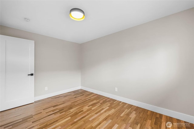 empty room featuring baseboards and wood finished floors