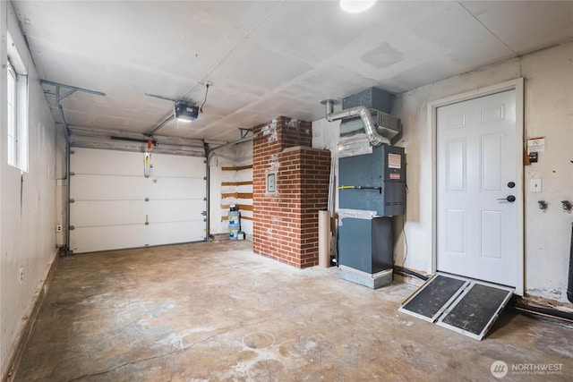 garage with a garage door opener and heating unit