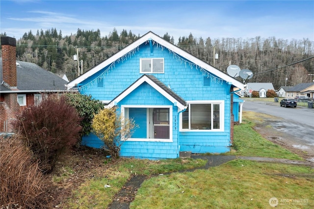 bungalow-style house featuring a front yard