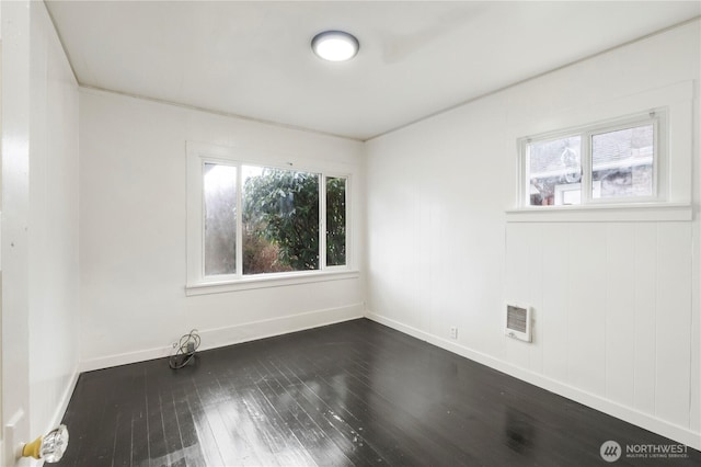 unfurnished room with dark wood-type flooring and baseboards