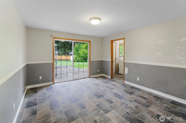 spare room featuring baseboards