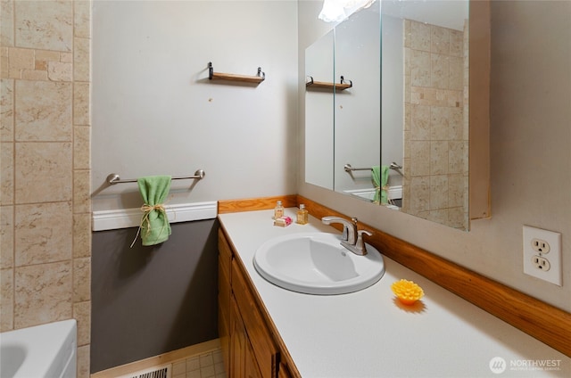 bathroom with vanity and a tub to relax in