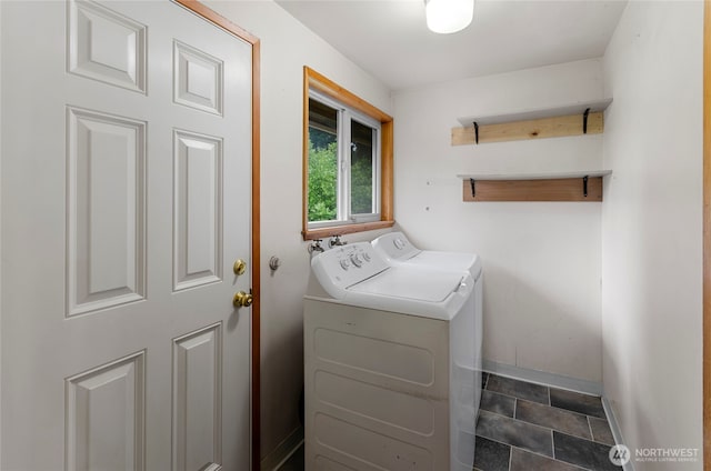 laundry room featuring baseboards, independent washer and dryer, and laundry area