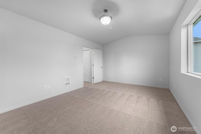 spare room with baseboards, carpet flooring, a healthy amount of sunlight, and visible vents