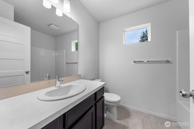 bathroom with walk in shower, vanity, toilet, and a wealth of natural light