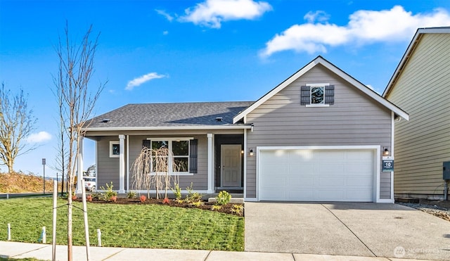 view of front facade with a garage, driveway, and a front lawn