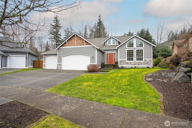 view of front of home with an attached garage, stone siding, driveway, and a front yard