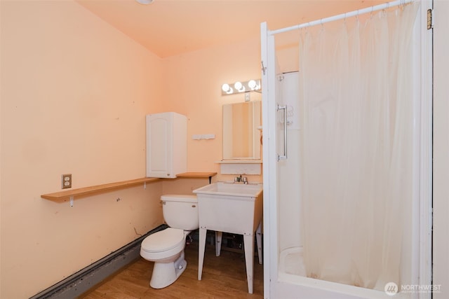 bathroom featuring a shower with curtain, toilet, and wood finished floors