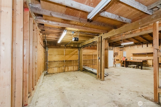 basement with a garage and electric panel