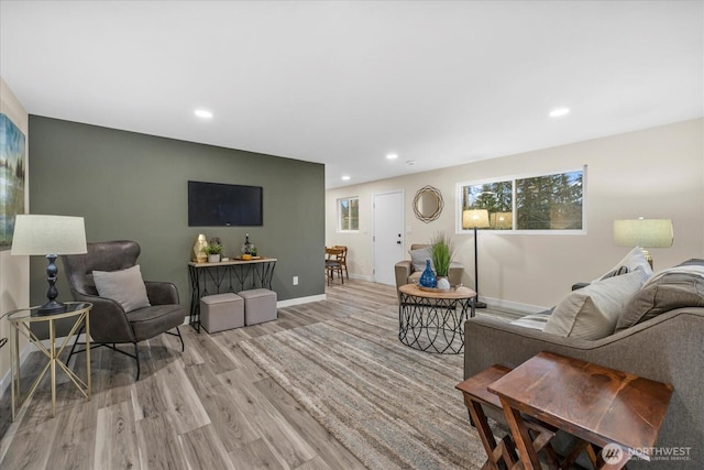 living room with light wood-type flooring, baseboards, and recessed lighting