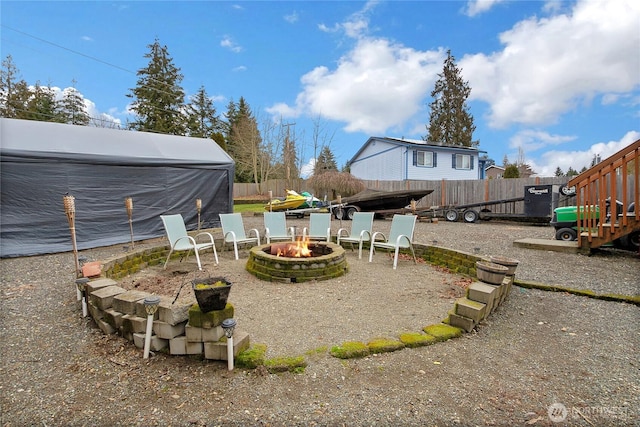 view of yard featuring a fire pit and fence private yard