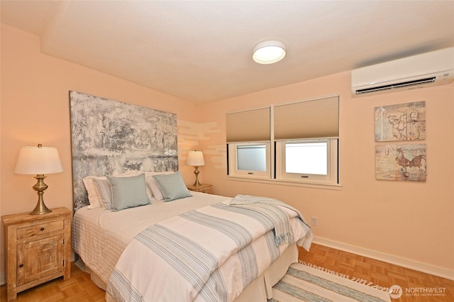 bedroom with a wall mounted air conditioner and baseboards