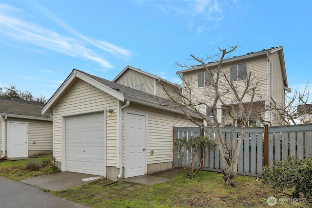 exterior space with a garage, fence, and an outdoor structure