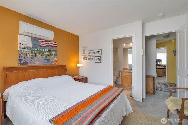 bedroom featuring light colored carpet, connected bathroom, and a wall mounted AC