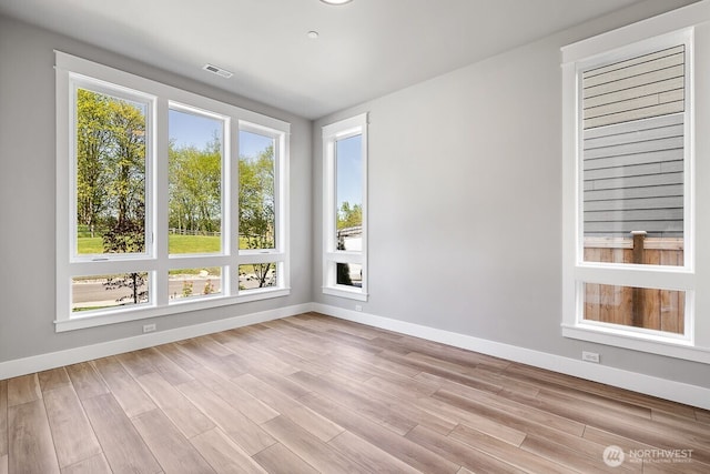 1424 238th St SE, Bothell, WA 98021 - spare room with visible vents, light wood-style flooring, and baseboards