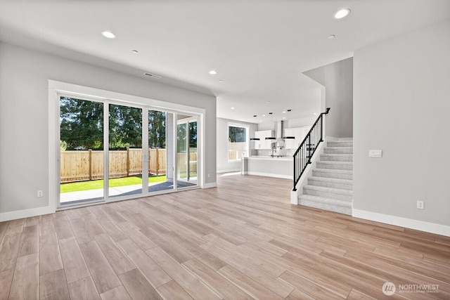 1424 238th St SE, Bothell, WA 98021 - unfurnished living room with recessed lighting, stairs, light wood finished floors, and baseboards