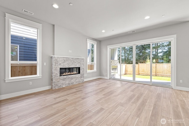 1424 238th St SE, Bothell, WA 98021 - unfurnished living room with recessed lighting, baseboards, visible vents, and light wood-style flooring