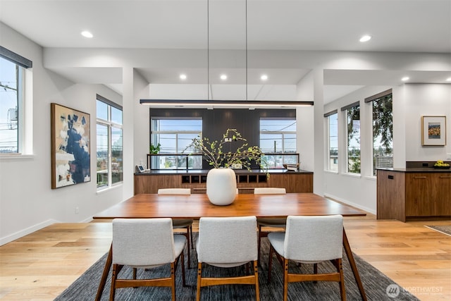 dining space featuring light wood-style floors, recessed lighting, and baseboards