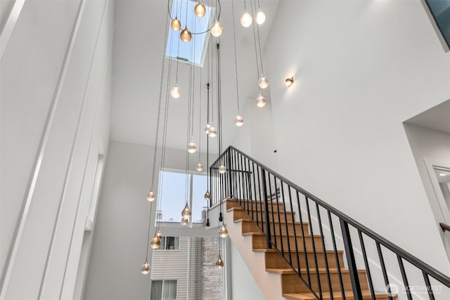 staircase with plenty of natural light and a high ceiling