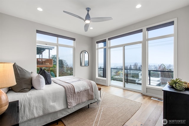 bedroom with access to exterior, recessed lighting, visible vents, and light wood-style flooring