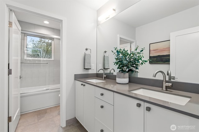 full bathroom with double vanity, shower / tub combination, and a sink