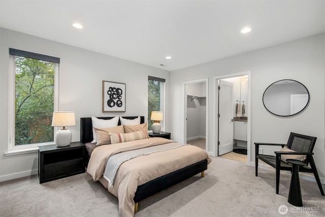 bedroom featuring recessed lighting, light colored carpet, and a spacious closet