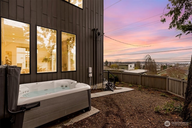 exterior space featuring a hot tub and fence