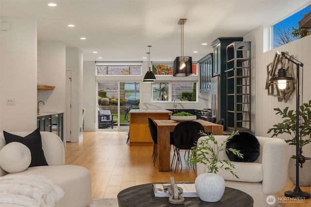 living room with wine cooler, recessed lighting, and light wood-type flooring