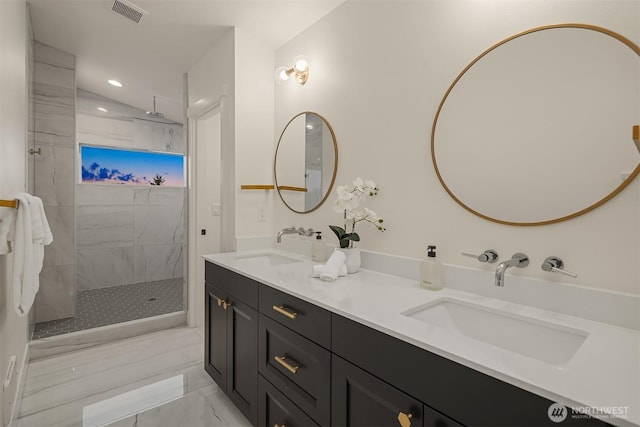 bathroom featuring a marble finish shower, visible vents, marble finish floor, and a sink