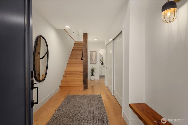 entryway featuring stairway, recessed lighting, baseboards, and light wood finished floors