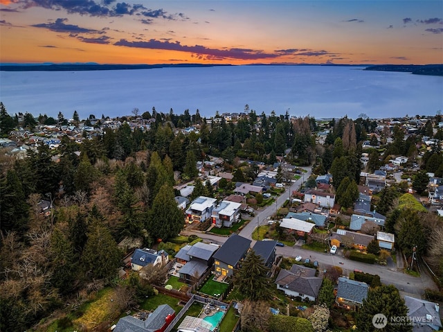 drone / aerial view with a water view and a residential view