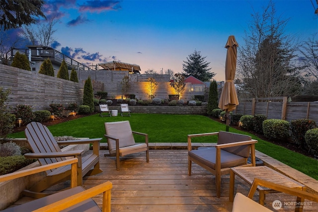 wooden deck with a yard and a fenced backyard