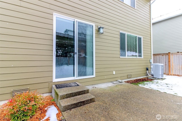 view of property exterior featuring crawl space, fence, central AC unit, and a patio