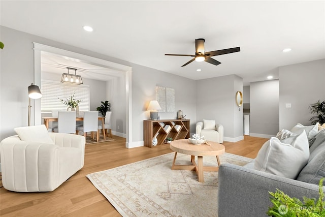 living area with a ceiling fan, light wood-type flooring, baseboards, and recessed lighting