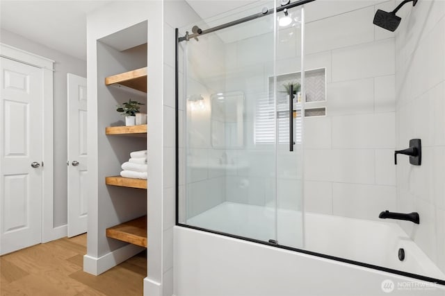 bathroom with combined bath / shower with glass door and wood finished floors