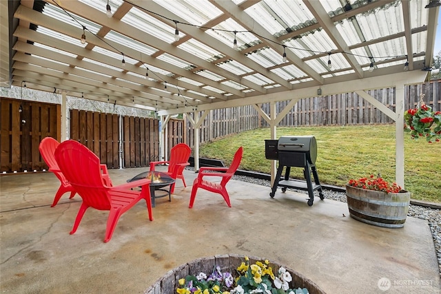 view of patio with a fenced backyard, a grill, a fire pit, and a pergola