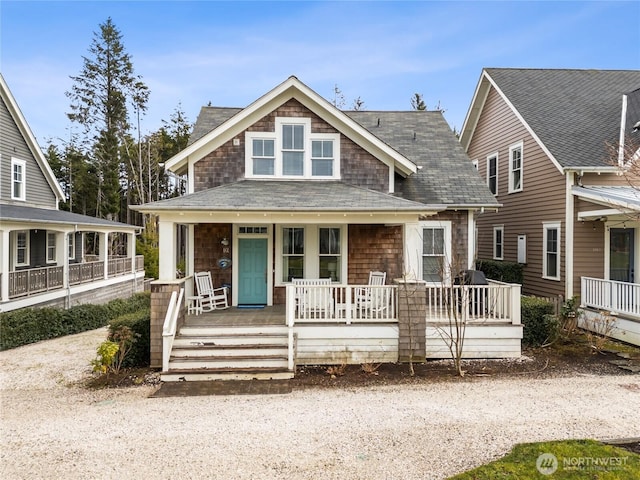 view of front of property featuring covered porch and roof with shingles