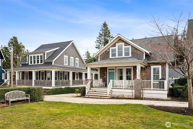 view of front of house with covered porch and a front lawn