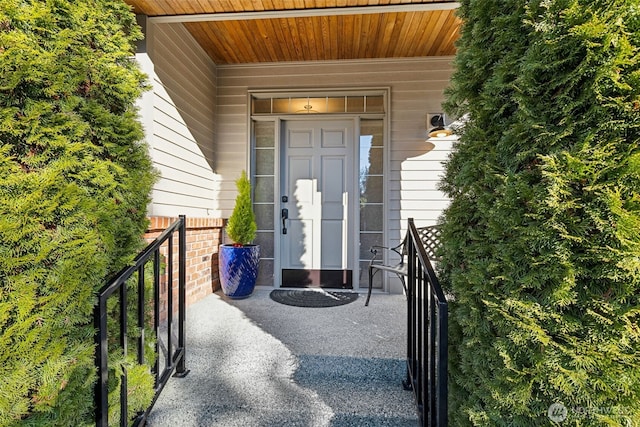 view of exterior entry with a porch