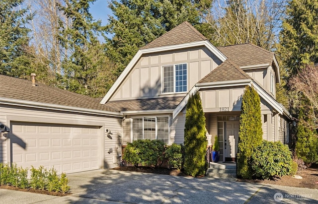 view of front of home featuring roof with shingles, board and batten siding, an attached garage, and driveway