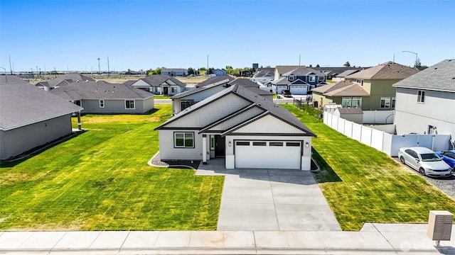 traditional home with an attached garage, driveway, a residential view, and a front yard