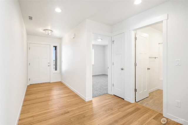 corridor featuring recessed lighting, baseboards, visible vents, and light wood-style flooring