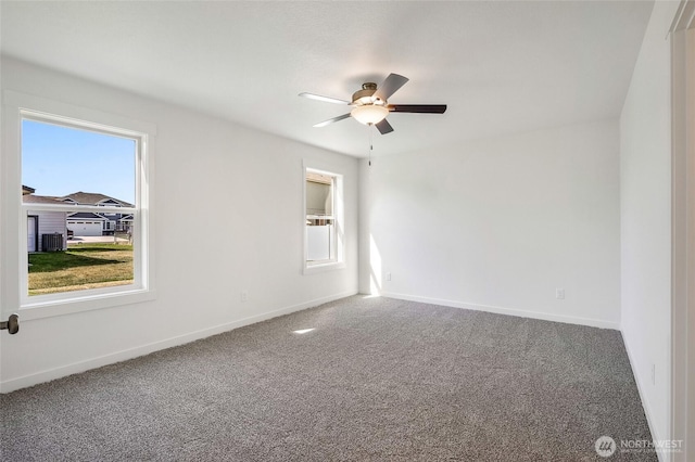 unfurnished room featuring carpet floors, baseboards, and a ceiling fan