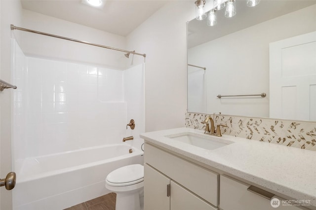 full bathroom with toilet, bathing tub / shower combination, and vanity
