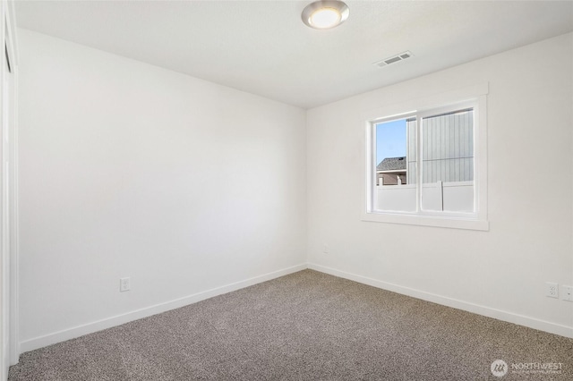 unfurnished room with carpet flooring, baseboards, and visible vents